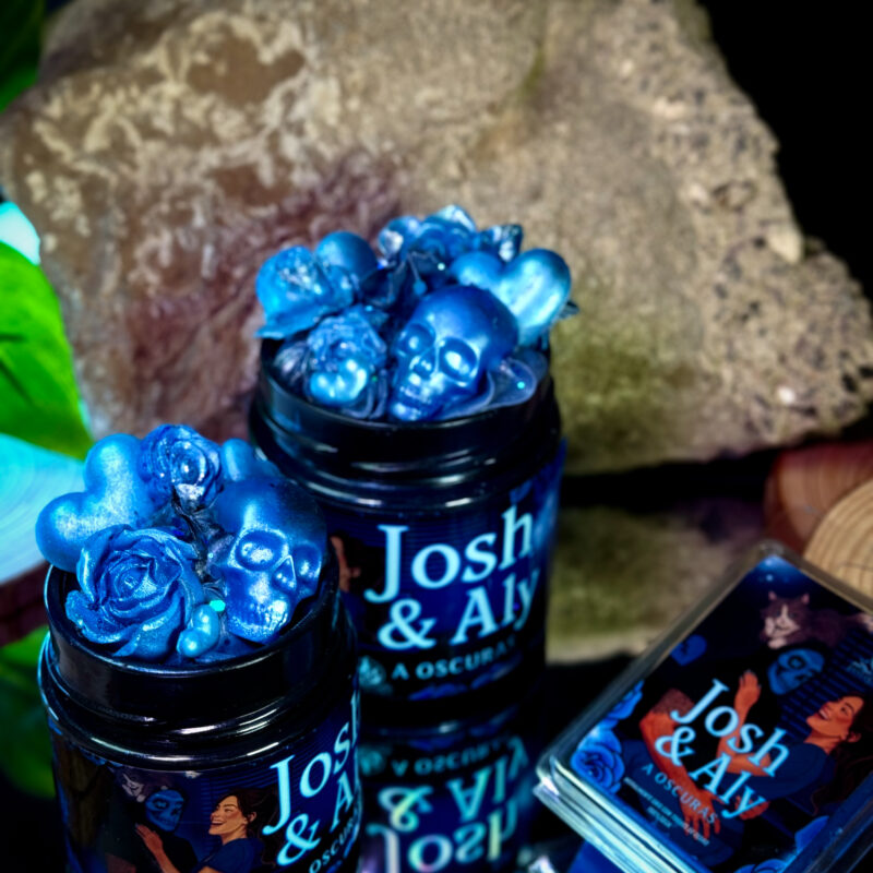 Velas literarias edición limitada A oscuras en formato mediano y grande, junto a tableta de MELTS de 120 g pintada a mano.